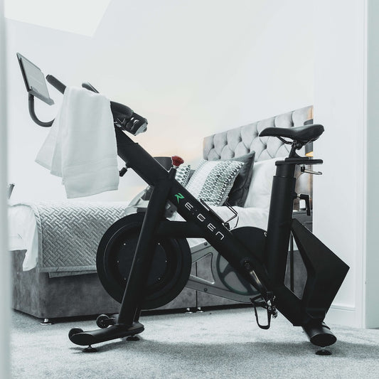 the RE:GEN bike in a bedroom with a towel over the handlebars
