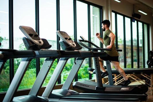 man running on treadmill in a gym